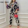 Szín: MULTI S - Elegáns női, háromnegyedes ujjú, mély V nyakú, végig nyomtatott, egyenes lábú, alkalmi jumpsuit